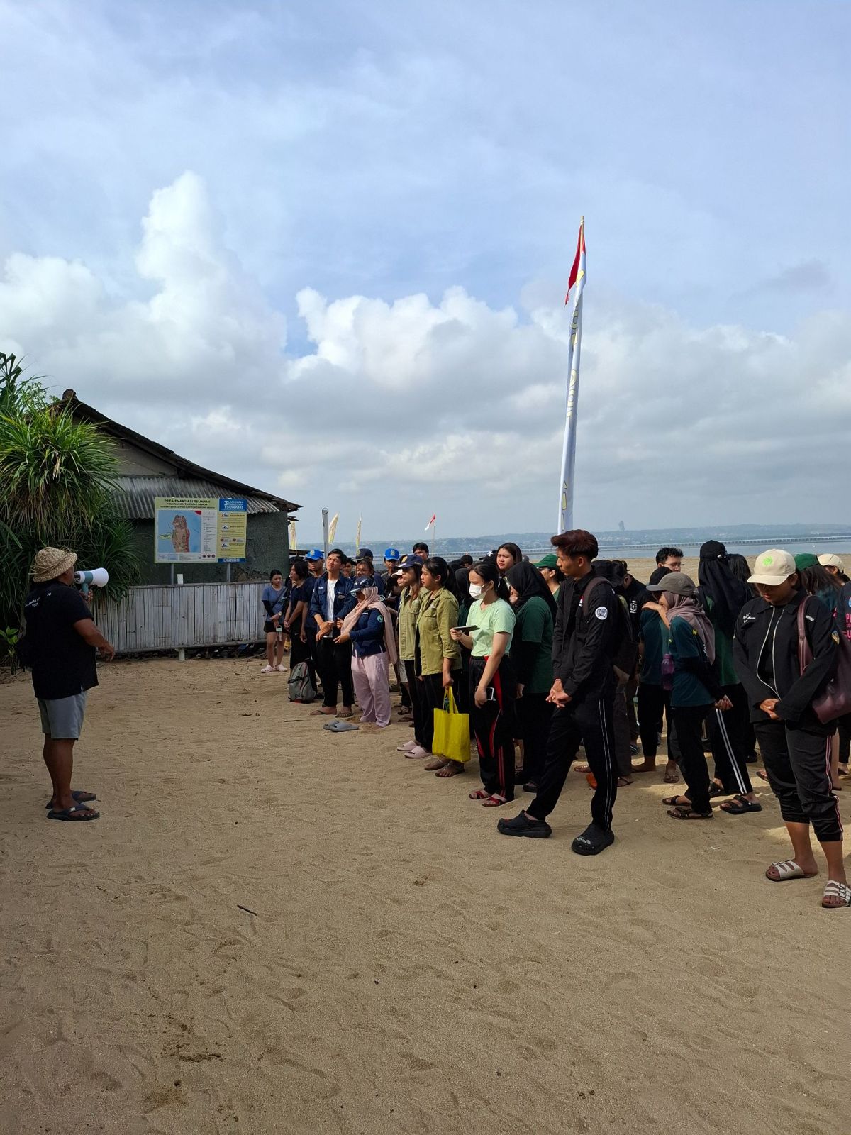 A group gathered on the beach before an activity