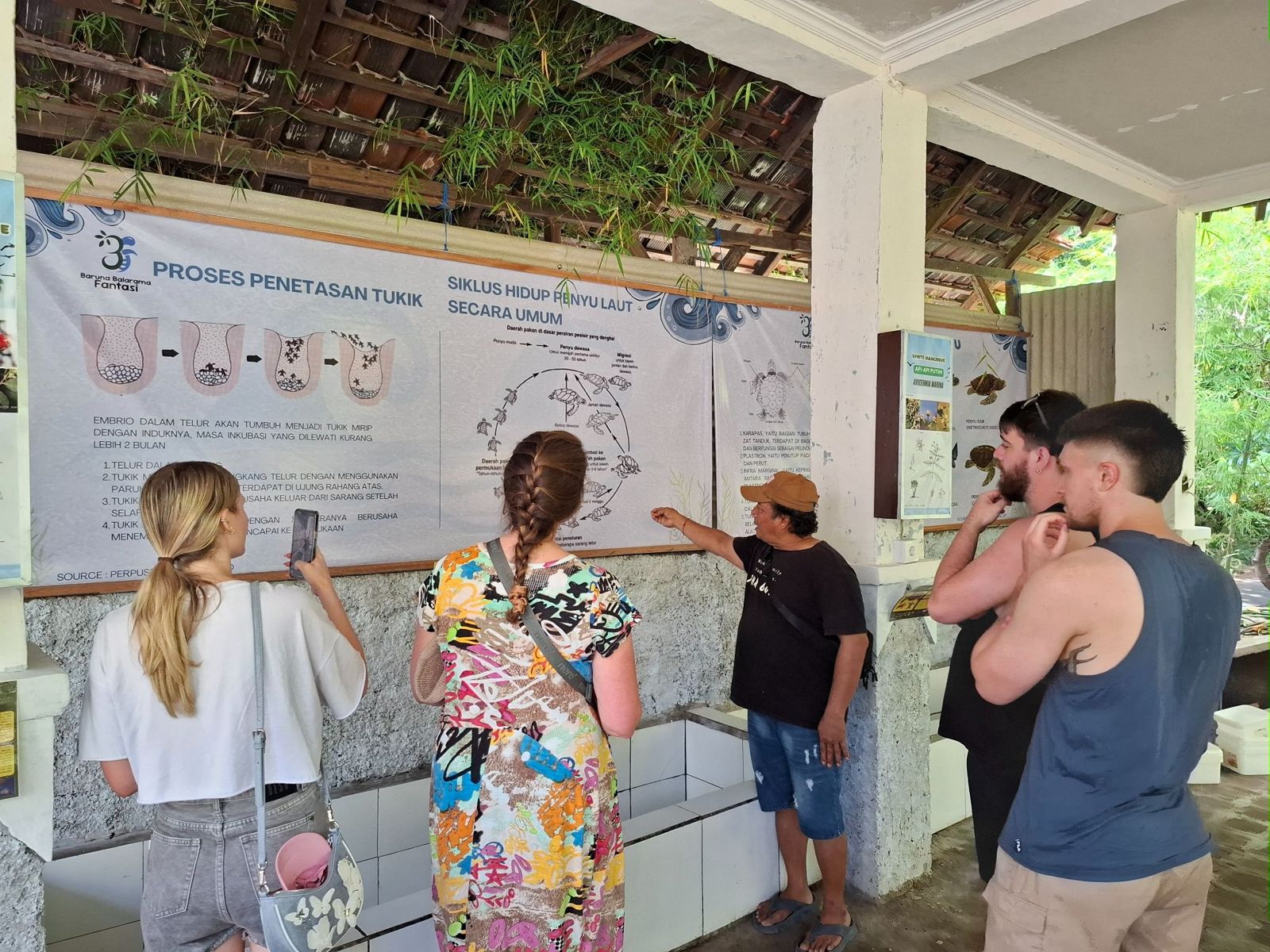 Visitors reading the educational panels at the center